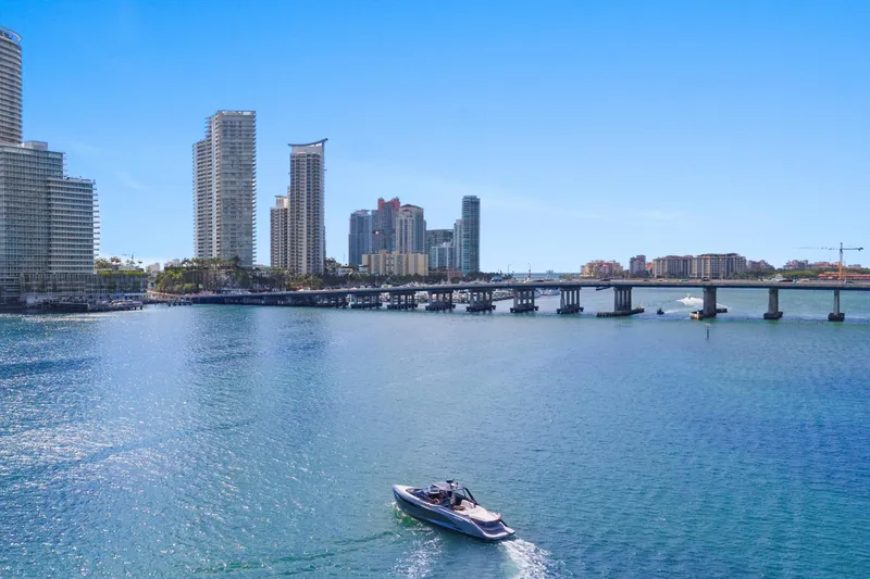 Slide: The Image of Boat cruising near city skyline and bridge, featuring a 2020 Princess R35 model. - 10