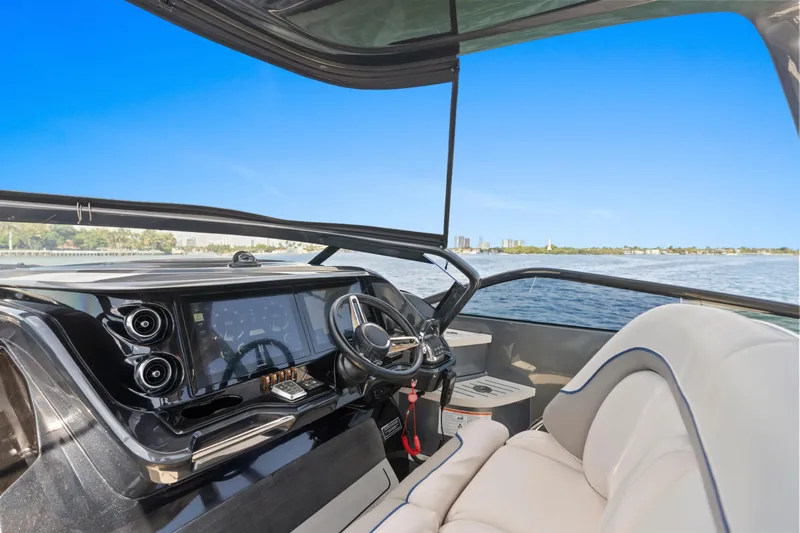 Slide: The Image of Luxurious 2020 Princess R35 yacht interior with modern dashboard and scenic water view. - 16