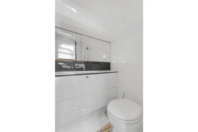 Slide: The Image of Modern yacht bathroom with sleek white fixtures, mirror, and sink. Princess R35, 2020 model. - 26