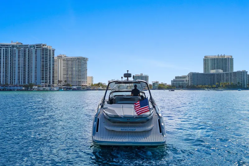 Slide: The Image of 2020 Princess R35 yacht cruising near city skyline, American flag displayed. - 3
