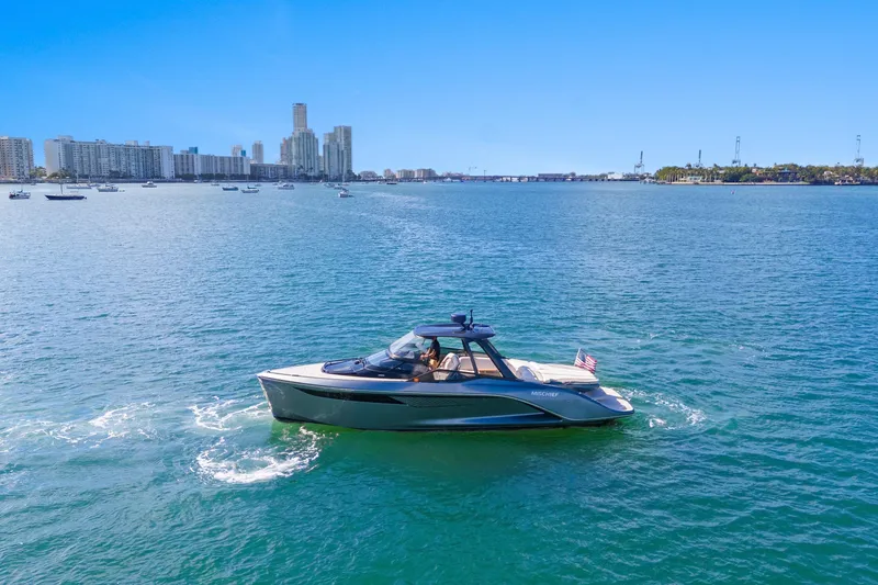Slide: The Image of Luxury Princess R35 yacht cruising in sunny waters, city skyline in background, 2020 model. - 5