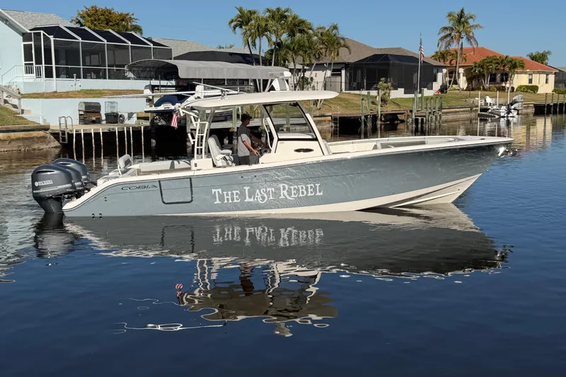 The Image of 2016 Cobia 344 Center Console boat named "The Last Rebel" on calm water. - 0