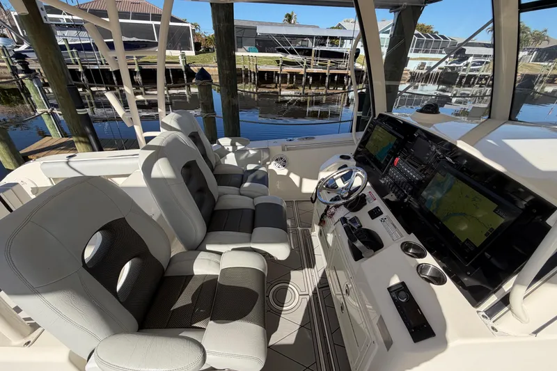 Slide: The Image of 2016 Cobia 344 Center Console boat interior with dual seats and advanced navigation system. - 14