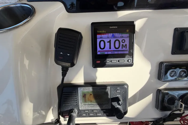 Slide: The Image of Cobia 344 Center Console 2016 dashboard with Garmin devices. - 19
