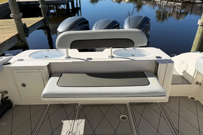 Slide: The Image of 2016 Cobia 344 Center Console boat with seating and twin engines at dock. - 21