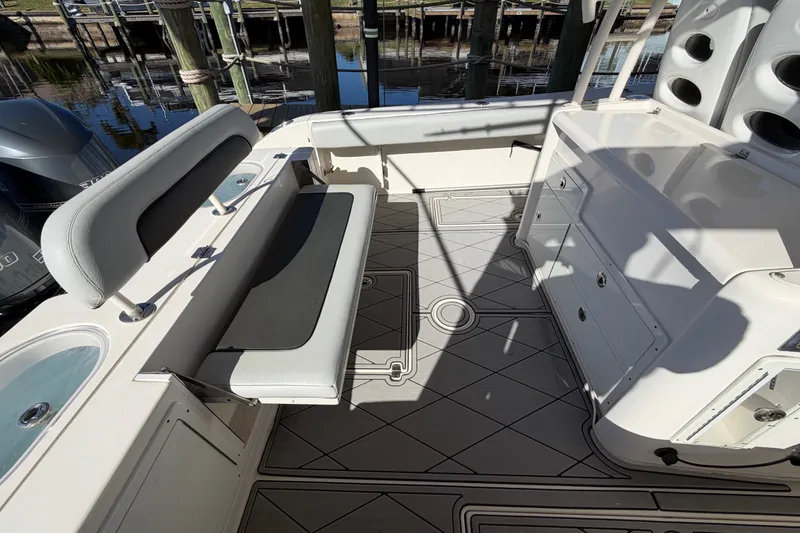 Slide: The Image of 2016 Cobia 344 Center Console boat interior with seating and storage compartments. - 22
