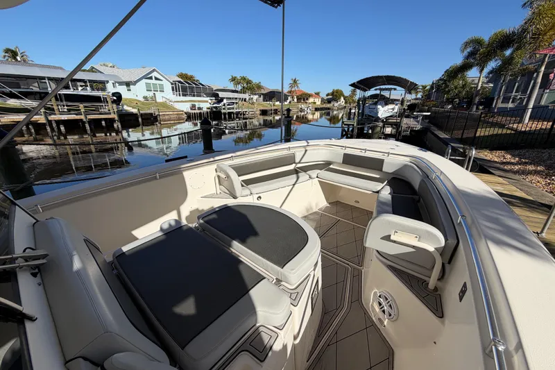 Slide: The Image of 2016 Cobia 344 Center Console boat docked in a scenic residential canal. - 26