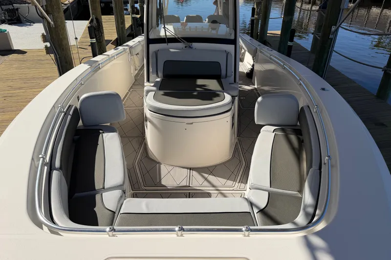 Slide: The Image of 2016 Cobia 344 Center Console boat interior with cushioned seating and sleek design. - 27
