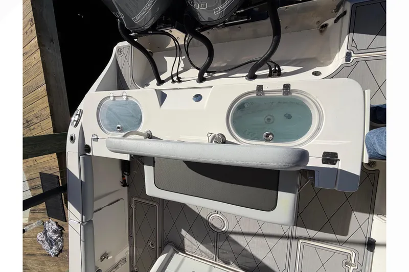 Slide: The Image of 2016 Cobia 344 Center Console boat deck with livewell and seating. - 34