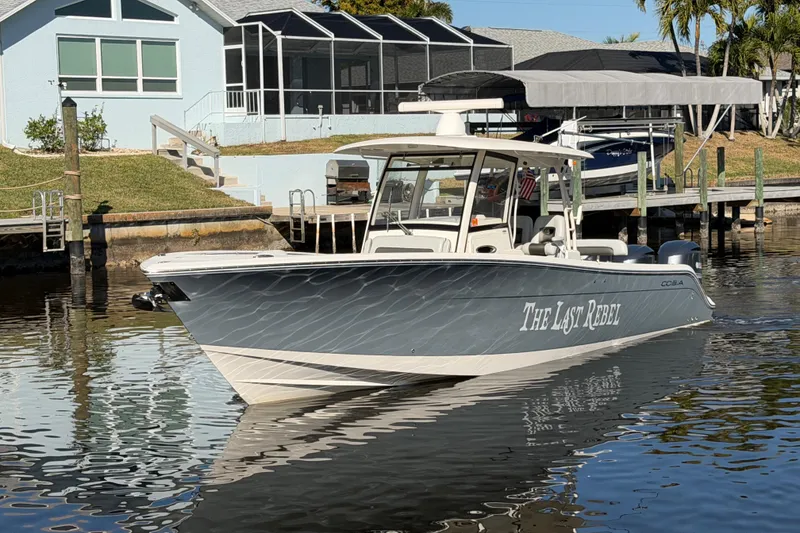 Slide: The Image of 2016 Cobia 344 Center Console boat docked near waterfront homes. - 4