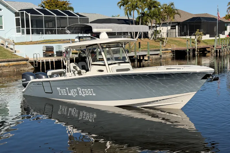Slide: The Image of 2016 Cobia 344 Center Console boat docked in a residential canal. - 5