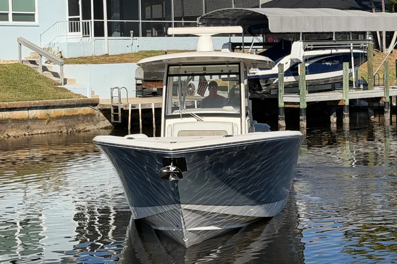 Slide: The Image of 2016 Cobia 344 Center Console boat docked near waterfront home. - 6
