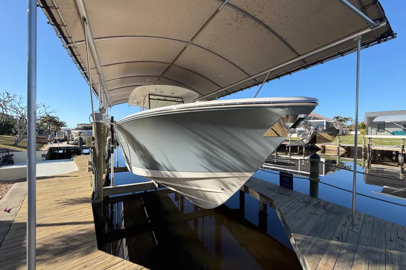 Slide: The Image of 2016 Cobia 344 Center Console boat docked under a canopy. - 9