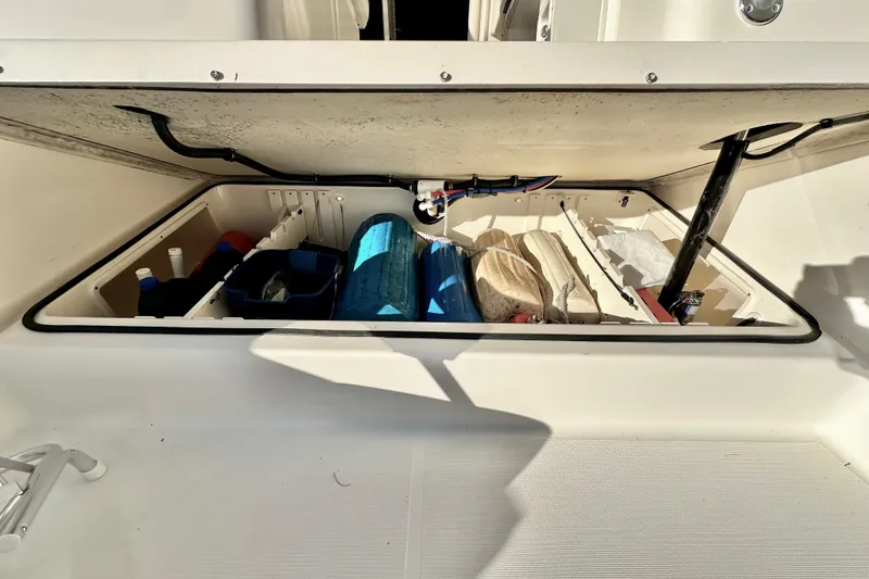 Slide: The Image of Storage compartment of a 2004 Pursuit 3070 Offshore boat, organized with supplies. - 100