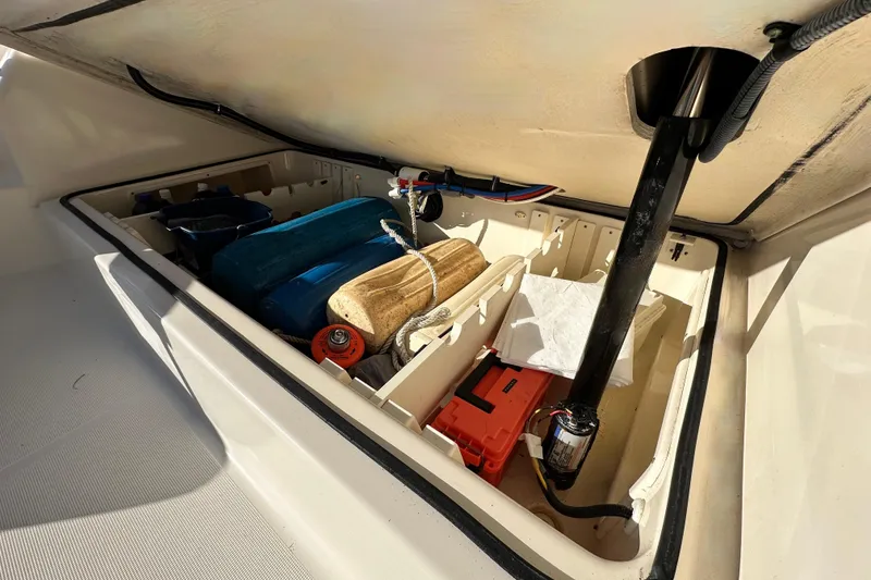 Slide: The Image of Storage compartment of 2004 Pursuit 3070 Offshore boat with various equipment. - 101
