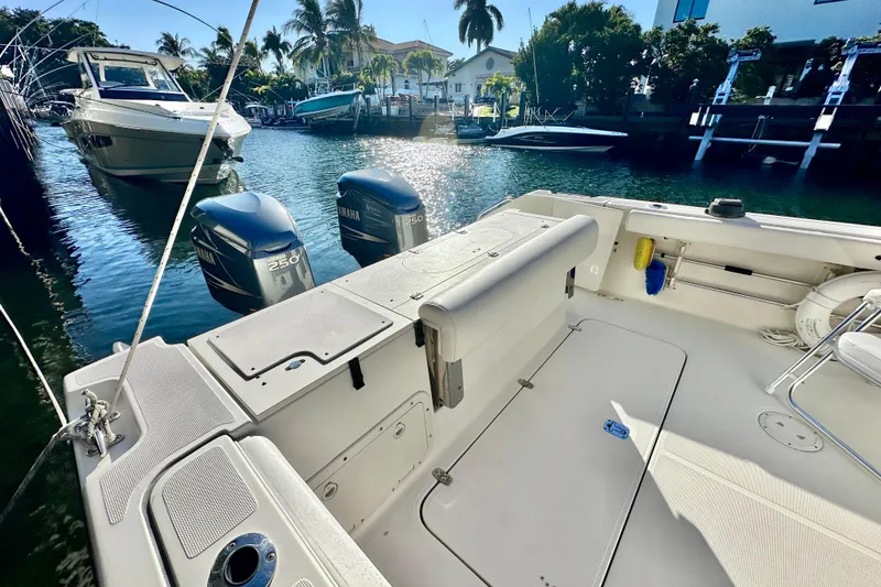 Slide: The Image of 2004 Pursuit 3070 Offshore boat with Yamaha engines docked in sunny marina. - 25