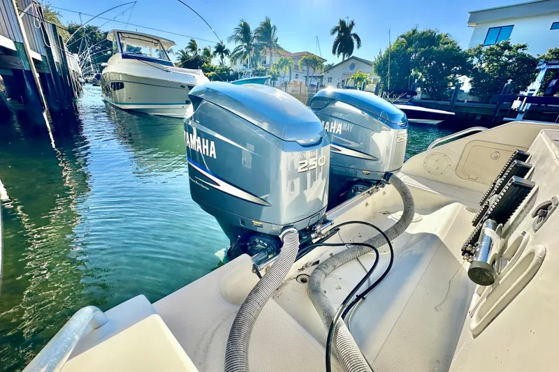 Slide: The Image of 2004 Pursuit 3070 Offshore boat with twin Yamaha 250 engines docked in sunny marina. - 26