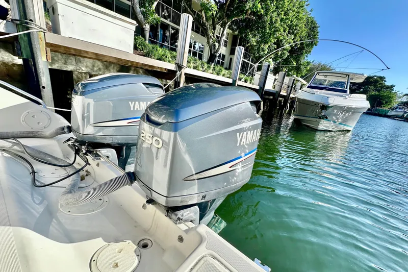 Slide: The Image of 2004 Pursuit 3070 Offshore boat with Yamaha 250 engines docked by waterfront. - 27