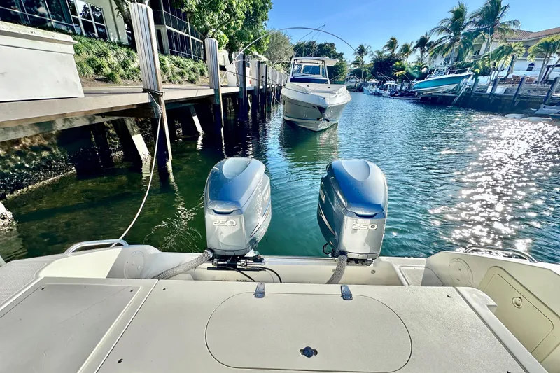 Slide: The Image of 2004 Pursuit 3070 Offshore boat with dual engines docked in a sunny marina. - 29