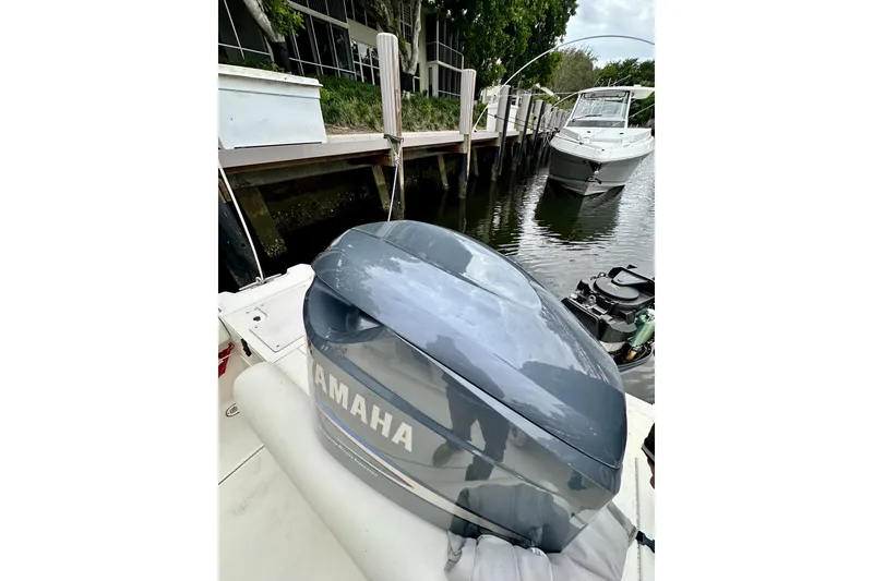 Slide: The Image of 2004 Pursuit 3070 Offshore boat with Yamaha outboard engine docked by a canal. - 31