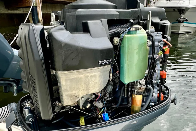 Slide: The Image of 2004 Pursuit 3070 Offshore boat engine, detailed view, docked in marina. - 32