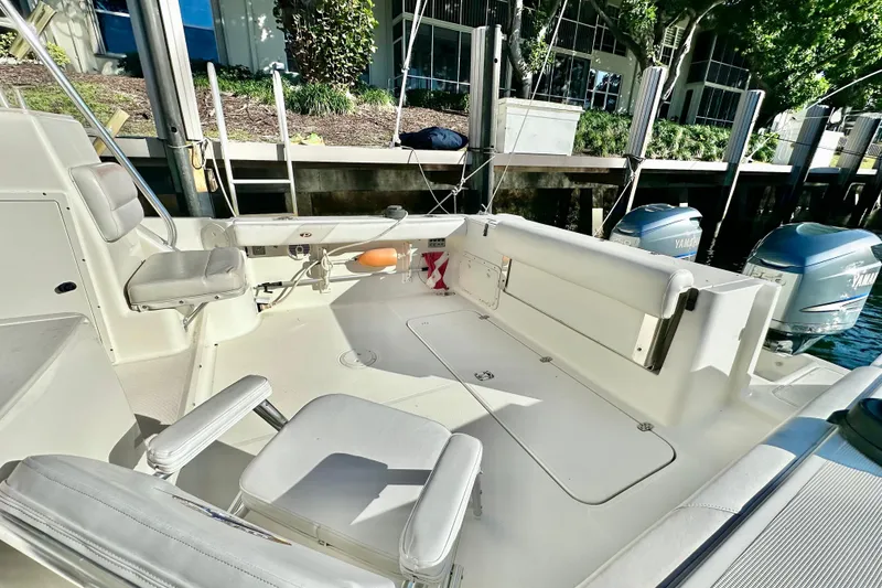 Slide: The Image of 2004 Pursuit 3070 Offshore boat interior with seating and Yamaha engines. - 34