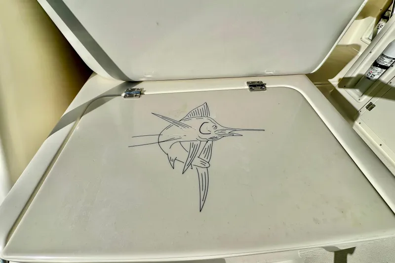 Slide: The Image of 2004 Pursuit 3070 Offshore boat hatch with marlin illustration. - 46