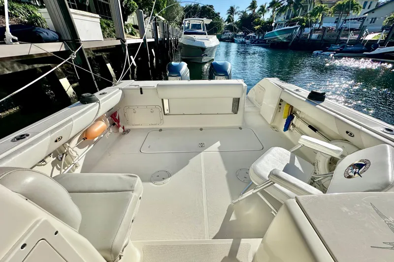 Slide: The Image of 2004 Pursuit 3070 Offshore boat interior, docked in a sunny marina setting. - 47