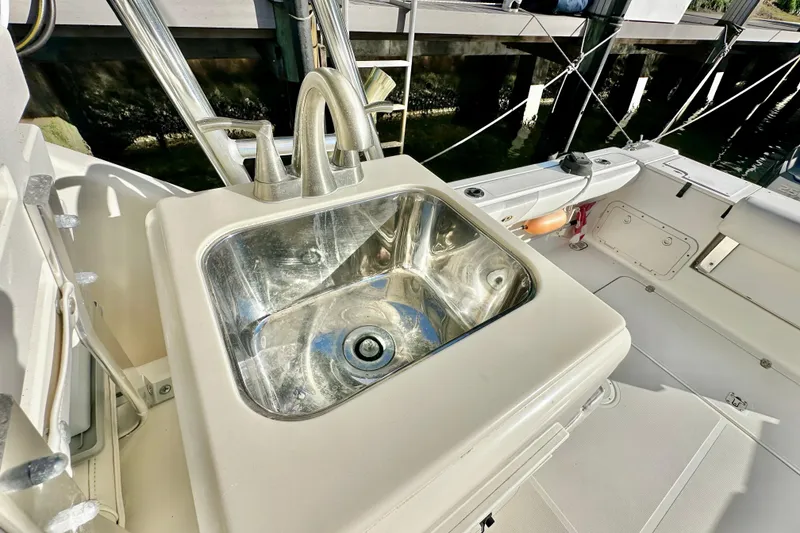 Slide: The Image of Stainless steel sink on 2004 Pursuit 3070 Offshore boat deck. - 48