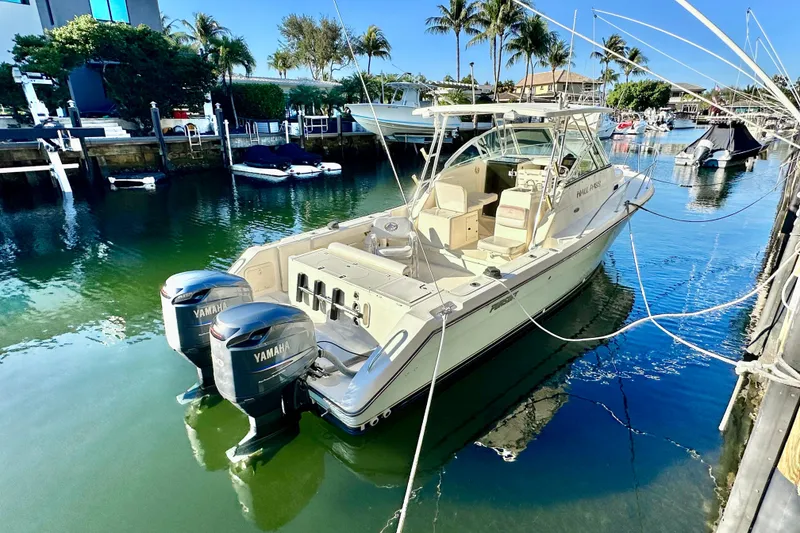 Slide: The Image of 2004 Pursuit 3070 Offshore boat docked with twin Yamaha engines. - 5