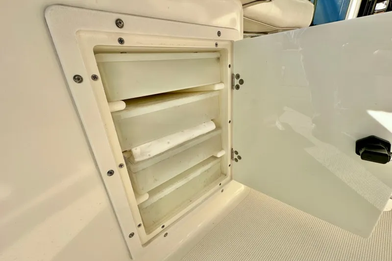 Slide: The Image of Open storage compartment on 2004 Pursuit 3070 Offshore boat. - 50