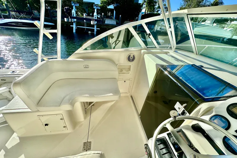 Slide: The Image of 2004 Pursuit 3070 Offshore boat interior with helm, seating, and water view. - 55
