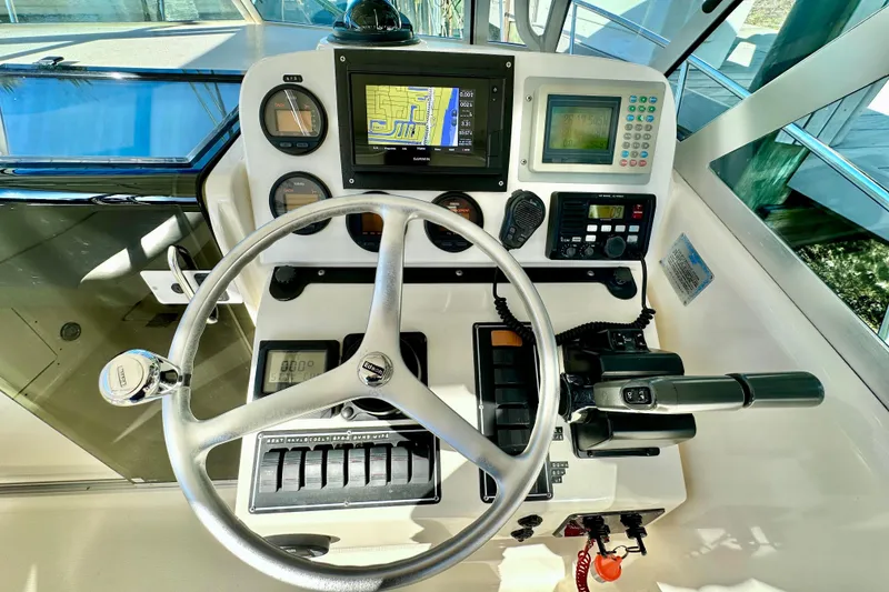 Slide: The Image of Control panel of a 2004 Pursuit 3070 Offshore boat with navigation equipment. - 59