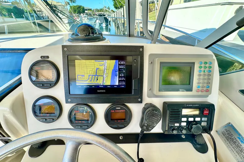 Slide: The Image of Dashboard of a 2004 Pursuit 3070 Offshore boat with navigation and communication equipment. - 60