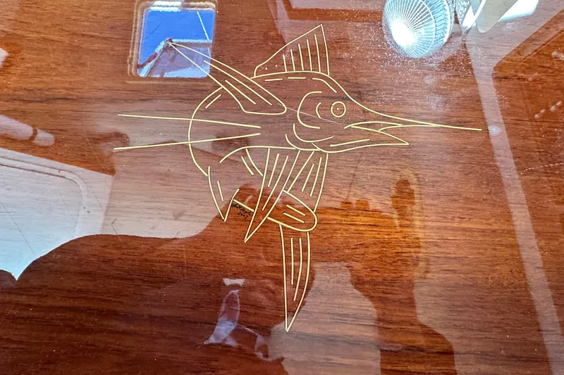 Slide: The Image of Engraved marlin design on 2004 Pursuit 3070 Offshore boat's wooden surface. - 69