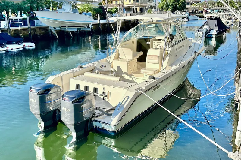 Slide: The Image of 2004 Pursuit 3070 Offshore boat docked with twin Yamaha 250 engines. - 7