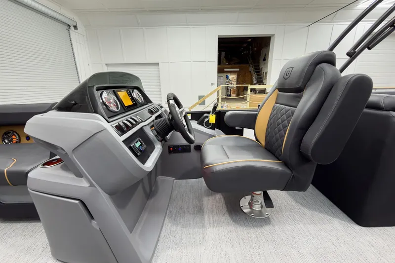 Slide: The Image of Luxurious interior of 2026 Godfrey Sweetwater 22' Split Bench Tritoon, featuring modern helm and seating. - 21
