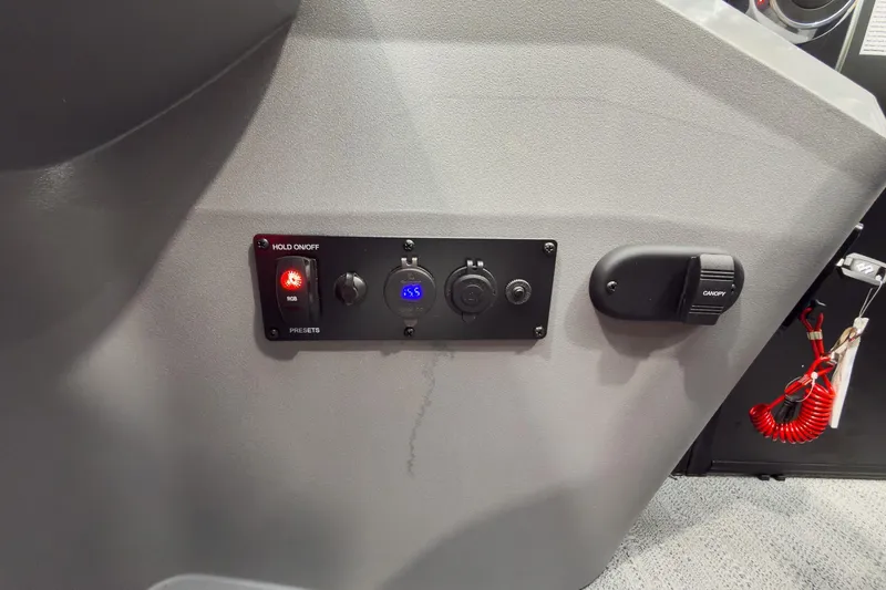 Slide: The Image of Control panel of 2026 Godfrey Sweetwater 22' Tritoon, featuring switches and a digital display. - 24