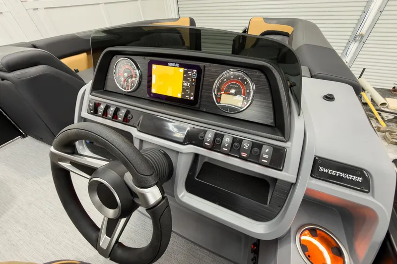 Slide: The Image of Steering console of 2026 Godfrey Sweetwater 22' Split Bench Tritoon with modern controls. - 25