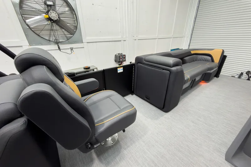 Slide: The Image of 2026 Godfrey Sweetwater 22' Tritoon interior with plush seating and modern design. - 27