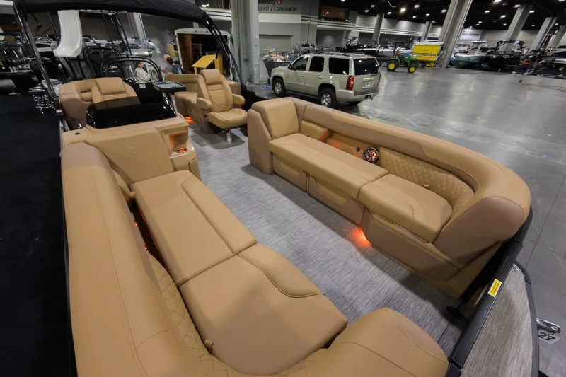 Slide: The Image of Luxurious interior of 2026 Godfrey Sweetwater 22' Split Bench Tritoon with tan seating. - 3