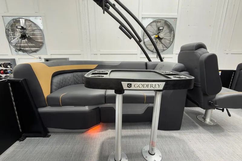 Slide: The Image of Interior of 2026 Godfrey Sweetwater 22' Split Bench Tritoon, featuring luxurious seating and table. - 30
