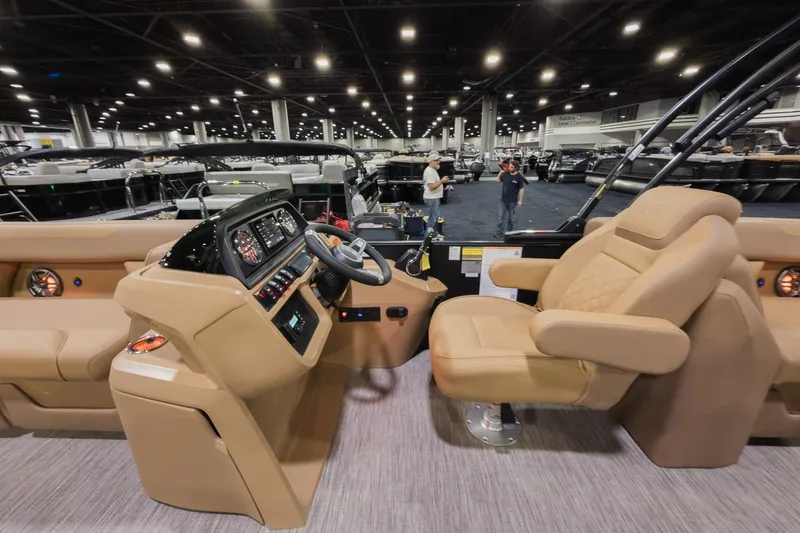 Slide: The Image of Interior of 2026 Godfrey Sweetwater 22' Split Bench Tritoon, featuring helm and seating. - 8