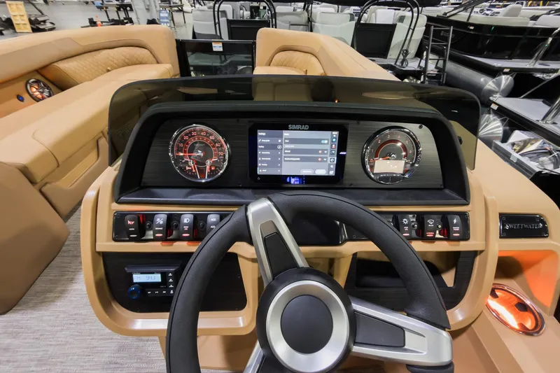 Slide: The Image of 2026 Godfrey Sweetwater 22' Tritoon dashboard with modern controls and steering wheel. - 9