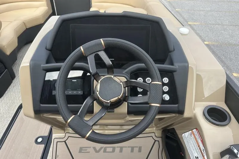 Slide: The Image of Steering wheel and dashboard of 2026 Evotti 723CS boat, featuring modern controls and design. - 14