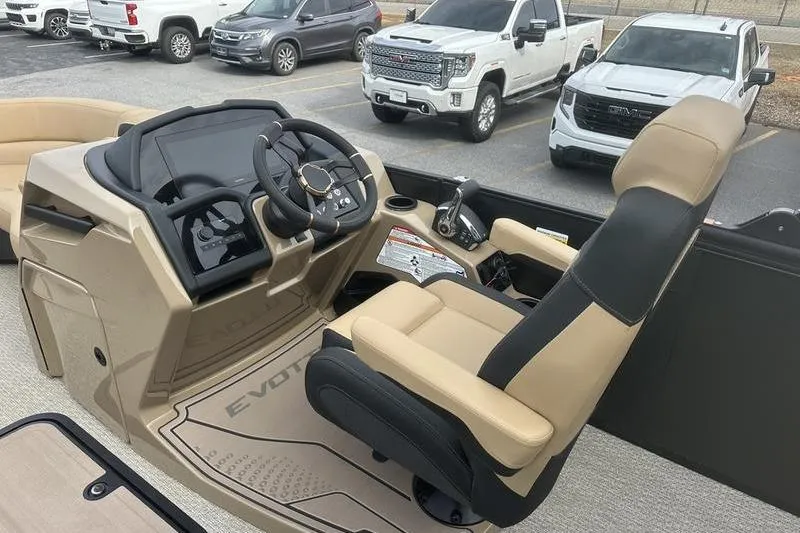 Slide: The Image of Captain's seat and helm of 2026 Evotti 723CS boat, featuring modern controls and steering wheel. - 15