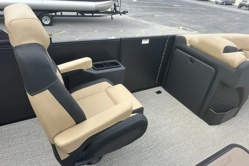 Slide: The Image of Evotti 723CS 2026 boat interior with beige and black seating, cup holder, and carpeted floor. - 18