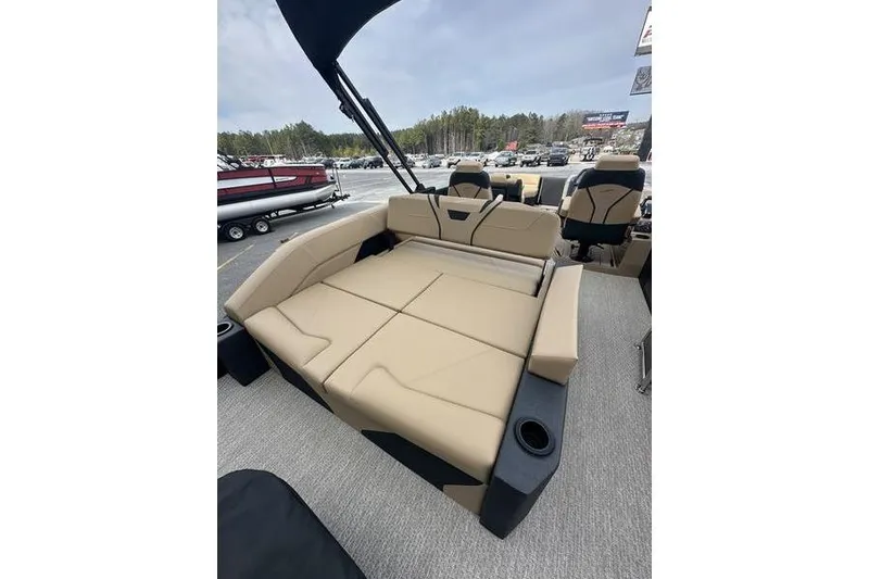 Slide: The Image of 2026 Evotti 723CS boat interior with beige seating and cup holders. - 23