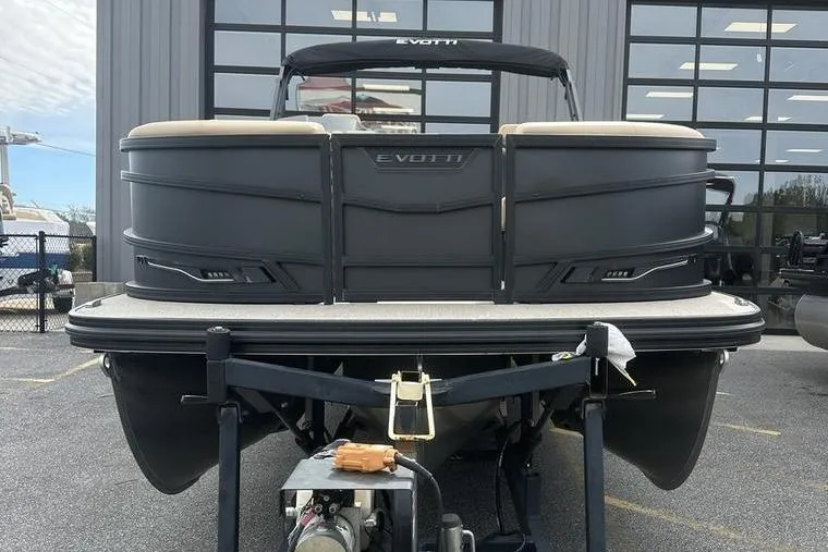 Slide: The Image of 2026 Evotti 723CS pontoon boat on trailer, parked outside a modern building. - 7