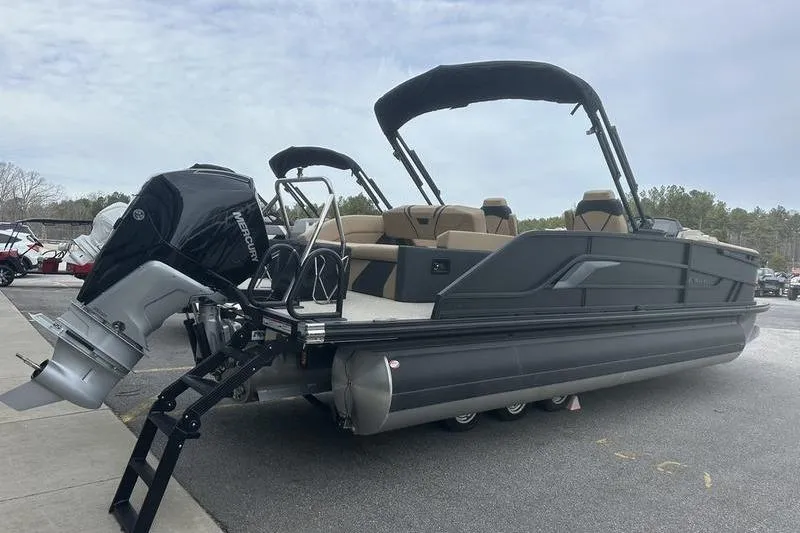Slide: The Image of 2026 Evotti 723CS pontoon boat with Mercury outboard motor, parked on pavement. - 9